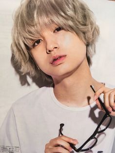 a young man with glasses and a stethoscope in front of a poster