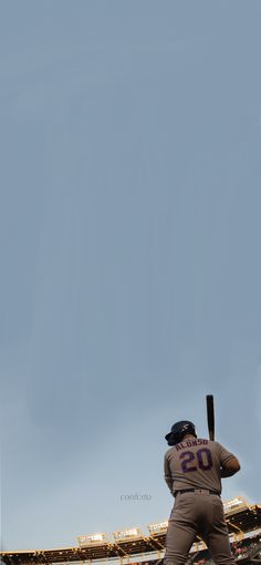 a baseball player holding a bat on top of a field in front of an empty stadium