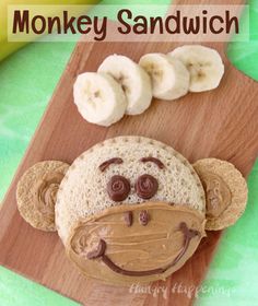 a monkey sandwich with peanut butter and banana slices on it, sitting on a cutting board