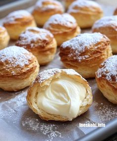 powdered sugar on top of pastries in a baking pan