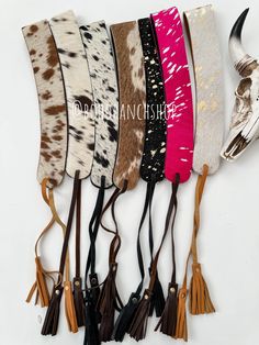 six cowhide headbands with tassels on each side and an animal's skull in the middle