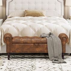 a white bed sitting in a bedroom on top of a rug