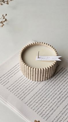 a candle sitting on top of an open book