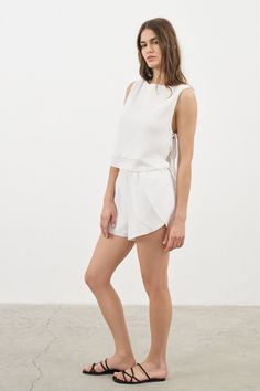 Looking for a genuine super soft and everyday top? Designed in a light silhouette, sleeveless Mia Side Ties Top White can be worn with ease all summer long and compliments most body types with adjustable side-ties. - 100% Turkish double layered gauze cotton - Side slits tied with adjustable side-ties.- Crop top finish at waist Chic Tops With Tie Waist For Vacation, Chic Tie Waist Tops For Vacation, Chic Sleeveless Top With Tie Waist, Short Beachwear Tops For Summer, Chic Short Tops For Daywear, Chic Short Beach Tops, Sleeveless Tie Back Tank Top For Summer, Spring Vacation Tops With Tie Waist, Spring Beachwear Tops Short Style