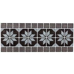 a black and white tile pattern on a wall