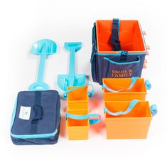 an assortment of beach toys sitting next to each other on a white surface with blue and orange handles