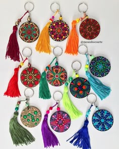 a bunch of key chains with tassels on them