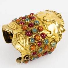 This is part of Chairish’s Costume Jewelry assortment.  A fabulous Gucci, Italy massive cuff bracelet, created by Alessandro Michéle for the Gucci Cruise Collection 2020 runway show. This cuff bracelet is patinated gold metal and features a mask, inspired by Greek and Mesopotamian antiquity. Embellished with colored resin beads. Assorted colors of orange sienna, turquoise blue, and burgundy red. A sublime sculptural piece, a jewel deserving as much to be worn as to be exhibited as an art object. Gucci Cruise, Store Inspiration, Aesthetic Dump, Runway Jewelry, Jewellery Exhibition, 2020 Runway, Metal Cuff Bracelet, Cruise Collection, Gucci Jewelry