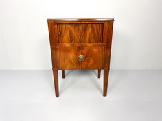 a wooden cabinet with two drawers on one side and an open drawer on the other