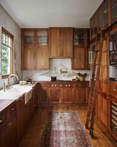 a kitchen with wooden cabinets and a ladder