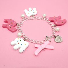 This frosted circus animal cookie bracelet is so whimsical, girly and fun, a perfect gift for any woman who loves cute charm jewelry, kawaii or pink. Handmade, the resin pendants are so realistic you may think they are real cookies! The cookie charms are on the larger side so this is definitely a statement piece. Available in your choice of gold or Silver finish.Details & Measurements: Pendants are hand-painted resin Pendants are 1.5" in size (3.75cm) Bracelet is 7.5" long (18.75 cm) Available in gold or silver finish Glass Pearls Baby Pink Bow Bead Finished with a Fatally Feminine Designs heart charm and toggle clasp Handmade More Animal Cookie Jewelry available, just search "animal Cookie"Shipping & Gift Options: item is handmade to order and will take around 1 week to process before shi Whimsical Charms Jewelry For Birthday, Whimsical Birthday Jewelry With Charms, Whimsical Charm Jewelry For Birthdays, Playful Dangle Personalized Jewelry, Cute Nickel-free Charm Bracelet For Friendship, Playful Pink Jewelry With Removable Charms, Playful Hypoallergenic Party Jewelry, Playful Hypoallergenic Jewelry For Party, Pink Fun Charm Bracelet