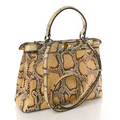 This is an authentic FENDI Snakeskin Medium Peekaboo Iconic Satchel in Tan. This stylish tote is crafted of beige snakeskin. This bag features a leather top handle with an optional shoulder strap and a structured frame across the top is secured by a turn lock on both sides. This bag opens to a beige suede and tweed interior with a zipper pocket. This is a perfect tote for everyday use from Fendi! Tweed Interior, Leather Top, Snake Skin, Top Handle, Zipper Pocket, Satchel, Fendi, Shoulder Strap, Zipper