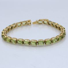 Indulge in the lush green beauty of our Peridot Tennis Bracelet, meticulously handcrafted in 18kt Yellow Gold. This exquisite piece of jewelry captures the essence of nature's freshness and combines it with the opulence of yellow gold, resulting in a bracelet that exudes sophistication and charm. Key Features: 🌿 Genuine Peridot Gemstones: Each peridot gemstone in this bracelet is ethically sourced and carefully chosen for its vibrant green hue and exceptional clarity. Peridot is a gemstone associated with vitality and abundance, making this bracelet a symbol of positive energy and style. 🌿 18kt Yellow Gold: The bracelet's setting and clasp are expertly crafted from 18kt yellow gold, adding a touch of timeless elegance and luxury to the design. Yellow gold's warmth complements the green o Peridot Gemstone, Green Beauty, Vibrant Green, Wedding Bracelet, Lush Green, Tennis Bracelet, Positive Energy, Bracelet Set, Timeless Elegance