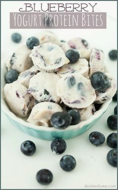 blueberry yogurt protein bites in a bowl with fresh blueberries on the side