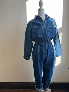 Amazing 1980s denim jumpsuit Boilersuit Big pockets Quality denim Big snap placket detail on the chest High waist Flattering fit Made by Dreams 100% cotton Size Medium - Large  Shoulder to shoulder 32" Chest 40" Waist 24-36" Hip 40" Inseam length 29" Torso length 16" Sleeve length 22" Retro Dark Wash Cotton Denim Jumpsuit, Vintage Denim Jumpsuit With Button Closure For Spring, Retro Medium Wash Cotton Denim Jumpsuit, Retro Cotton Denim Jumpsuit In Medium Wash, Vintage Denim Blue Jumpsuit With Pockets, Vintage High Rise Denim Jumpsuit, Vintage Cotton Denim Jumpsuit In Medium Wash, Vintage Denim Blue Cotton Jumpsuit, Vintage Dark Wash Cotton Denim Jumpsuit