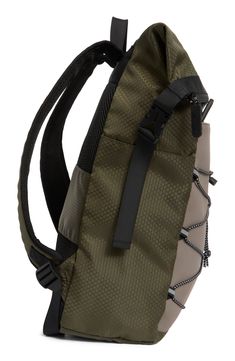 a green backpack with black straps on it