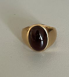 Signet ring in yellow gold (18k) adorned with an oval cabochon garnet in a bezel setting. Gross Weight: 8.16 g. Size: 47 Possibility of sizing, contact us. Further information : We issue an invoice as well as a certificate of authenticity established by our qualified gemologist (LFG Paris). Our photos are not reworked and are taken in a natural light environment. We can send you a short video upon simple request. Each piece of jewelry is delivered in a box. Each shipment is made with insurance a Fine Jewelry Oval Cabochon Signet Ring For Formal Occasions, Fine Jewelry Oval Cabochon Signet Ring For Formal Wear, Formal Fine Jewelry Signet Ring With Cabochon, Formal Cabochon Signet Ring, Formal Yellow Gold Signet Ring With Oval Cabochon, Modern Yellow Gold Signet Ring With Cabochon, Classic Yellow Gold Signet Ring With Cabochon, Formal Cabochon Ruby Ring, Modern Gold Signet Ring With Cabochon