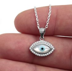 925 sterling silver evil eye pendant necklace with mother of pearl evil eye and cz stones. White Gold Sterling Silver Evil Eye Jewelry, Sterling Silver Evil Eye Jewelry, Silver Sterling Evil Eye Jewelry, Silver Sterling Silver Evil Eye Jewelry, Evil Eye Silver Jewelry In Sterling Silver, Sterling Silver Jewelry With Diamond Eyes, White Sterling Silver Jewelry With Diamond Eyes, Silver Evil Eye Fine Jewelry Necklace, Silver Evil Eye Necklace In Fine Jewelry Style