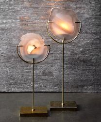 two white flower shaped lights sitting on top of each other