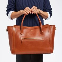 Whether you're working from home, the office or the road, the super-functional Zoe Leather Work Tote is designed to keep your daily essentials organized. Handcrafted in Turkey from beautifully soft pebbled leather, this carry-it-all classic features an outside zip pocket for easy access to your phone or hand sanitizer, soft padded carry handles and an adjustable crossbody strap so you can tote your essentials with ease. The super-organized interior has a padded laptop sleeve that fits up to a 15 Classic Laptop Bag With Zipper Closure For Work, Leather Laptop Bag With Zipper Pocket For Office, Versatile Leather Satchel For Work, Classic Office Satchel With Zipper Closure, Elegant Leather Laptop Bag With Zipper Pocket, Leather Laptop Bag With Zipper For Work, Leather Laptop Bag For Work With Zipper Closure, Leather Briefcase With Zipper For Work, Versatile Leather Laptop Bag For Work