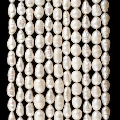 a bunch of white pearls on a black background