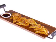 some food is sitting on a wooden tray