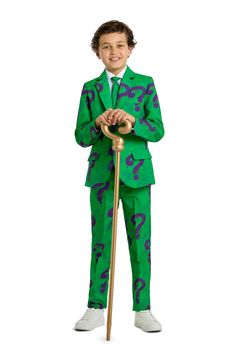 a young boy in a green suit and tie holding an umbrella with question marks on it