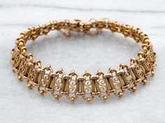 This beautiful yellow 18-karat gold Victorian bracelet is adorned with ornate links for an eye-catching look. Crafted from solid gold, it's perfect for adding a touch of luxury to any outfit. Metal: 18K Yellow Gold Width: 14.9 mm Inside Circumference: 7 Inches Marks: "18" Stamped on the clasp To view a video of this piece check out the link below:  https://vimeo.com/911342170 SKU #: A35914 Each piece has been identified and graded by a Graduate Gemologist who has been certified by the Gemologica Victorian Bracelet, Gold Link Bracelet, Pocket Watch Chain, Box Clasp, Pearl Pendant, Chain Link Bracelet, Charm Earrings, New Hampshire, Beaded Chain