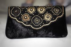 Classic vintage look of this beautiful handbag will add a touch of persona and charm. This clutch bag for wedding is made up of intricately designed victorian pattern with crystal embellishments on the middle of floral decoration. This bag is unique and stands different from wedding clutches that are currently in the market. This handbag is a timeless piece of art covered in velvet fabric. Victorian Handmade Evening Bag For Formal Occasions, Bohemian Embellished Shoulder Bag For Wedding, Bohemian Wedding Pouch Clutch, Bohemian Embellished Wedding Shoulder Bag, Handmade Elegant Bags For Vintage Events, Antique Handmade Evening Bag For Wedding, Handmade Antique Evening Bag For Wedding, Handmade Victorian Evening Bag, Elegant Handmade Bags For Vintage Events