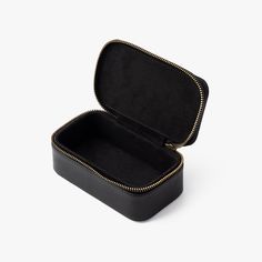 Meticulously crafted to securely store a single Brackish bow tie both at home and away. Our sleek yet durable black travel box features faux leather, antique brass hardware and is finished with an embossed Brackish logo. Classic Black Rectangular Case, Classic Black Case As Gift, Classic Black Cases As Gift, Classic Black Cases For Gifts, Classic Black Portable Cases, Classic Portable Cases For Gifts, Portable Black Cases As Gift, Portable Black Cases For Gifts, Black Portable Case For Gift