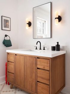 a bathroom with two sinks and a large mirror