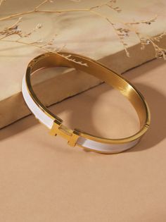 Embrace timeless elegance with this delicate gold bangle. This bracelet will make a cherished addition to your everyday style. Altar'd State Jewelry, Fall School, Bow Bracelet, Bangles Making, Stacked Jewelry, Bangle Designs, Gold Bangle, Cross Bracelet, Altar'd State