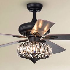 a ceiling fan with two lights and a caged light fixture