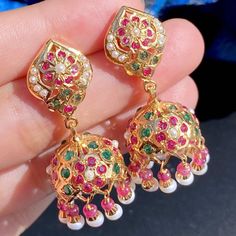 Featuring a small and light weight jadau jhumka for women made in sterling silver with gold plated. The jhumka has been studded with ruby like red stones, emerald like green stones and freshwater pearls. The studded stones comprise real rubies and freshwater pearls. The jhumka earrings close with a threaded bombay screw. Bollywood Style Kundan Jhumkas With Hallmark, Hallmarked Kundan Jhumkas For Festivals, Ruby Chandbali Jhumkas With Intricate Design, Ruby Chandbali Jhumkas For Celebration, Ruby Jhumkas With Intricate Design In Temple Jewelry Style, Festive Ruby Jhumkas In Temple Jewelry Style, Traditional Ruby Jhumkas With Latkans, Festive Ruby Jhumkas With Intricate Design, Ruby Temple Jewelry Jhumkas For Festive Occasions