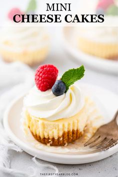 a small cupcake with whipped cream and berries on top