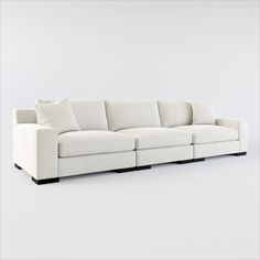 a white couch sitting on top of a white floor