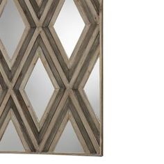 a mirror that is sitting on top of a wooden wall mounted cabinet with diamond design