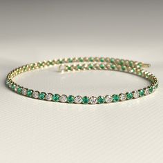 This 1.96 Carat Natural Emerald & Diamond Alternate Dainty Tennis Bracelet in 14K Yellow Gold beautifully blends vibrant emeralds with sparkling lab-grown diamonds. Perfect for stacking or wearing solo, this elegant bracelet is a timeless piece of luxury. Crafted with attention to detail, it makes a thoughtful birthday present, adding a sophisticated touch to her jewelry collection. A stunning combination of fine craftsmanship and natural beauty, ideal for any special occasion. 𝐅𝐞𝐚𝐭𝐮𝐫𝐞𝐬: Stacked Wedding Rings, Diamond Tennis Bracelet, Elegant Bracelet, Band Bracelet, Engagement Rings Oval, Tennis Bracelet Diamond, Emerald Diamond, Natural Emerald, Birthday Present