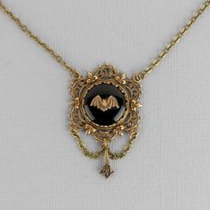 "This brass filigree and black glass necklace will add a touch of Victorian Gothic charm to your outfit. It would make a fabulous gift for any bat lover. 💀 DESCRIPTION: This elegant Y necklace features a small bat stamping that was hand set onto a vintage jet black cabochon. It was set into a lace edge setting and then layered onto an ornate filigree with Fleur de Lis detailing. The filigree is adorned with chain and an Art Deco style drop. The cable chain was finished with a lobster clasp and Bat Pendant, Flying Bat, Skull Purse, Crow Skull, Brass Filigree, Victorian Goth, Y Necklace, Metal Girl, Pet Necklace