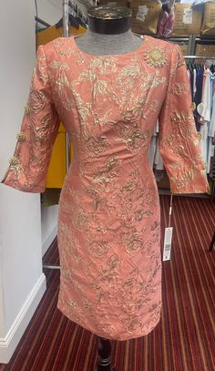 Lily and Taylor 4469 1 piece Jacquard Dress Colors: Coral/Gold, Ivory/Gold Sizes: 4, 6, 8, 10, 12, 14, 16, 18, 20, 22, 24 Matching Hat: Call (469)571-3647 or email DivasDenFashion@gmail.com to purchase hat Festive Formal Brocade Dress, Festive Brocade Formal Dress, Festive Brocade Dress For Formal Occasions, Festive Party Dresses In Jacquard Material, Fitted Long Sleeve Brocade Dress, Festive Party Dress In Jacquard, Festive Jacquard Party Dress, Formal Gold Jacquard Dress, Gold Jacquard Party Dress