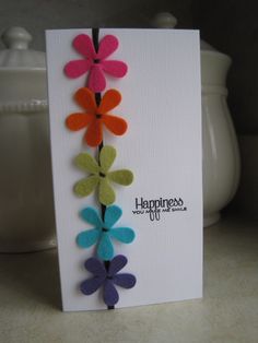 a greeting card with colorful felt flowers on it