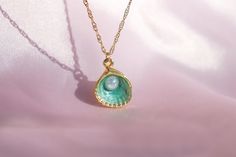 🌊 🐚 In the heart of an underwater kingdom, a green oyster pendant with a shimmering pearl was discovered. This necklace brings a touch of ocean magic and mermaid charm to your everyday style. ✨ 🎁 Your order will arrive in a pre-packaged special and cute box. Ready to be gifted to yourself or someone you care about! 🔍 DETAIL * Material: High quality of Gold Plated Brass * Chain Length: 40 +5 cm / 15.75 +1.95 inches (At the chain's end there is a + 5cm/1.9 inch extension) 📦 SHIPPING * Our pro Ocean-inspired Pearl Pendant Necklaces As Gifts, Green Pearl Pendant Jewelry Gift, Green Pearl Drop Necklace Gift, Green Pearl Pendant Jewelry As Gift, Green Pearl Drop Necklace For Gift, Pearl Pendant Jewelry For May Birthstone Gift, Ocean-inspired Pearl Pendant Jewelry, Green Pearl Necklace As A Gift, Green Pearl Necklace For Gifting