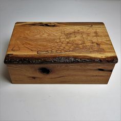 a wooden box sitting on top of a white table