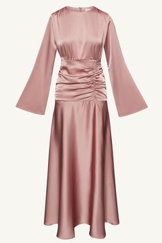 Indulge in luxury and sophistication with our Shams Satin Side Rouched Maxi Dress in Dusty Rose. The elegant hue is enhanced by the side rouched detailing, creating a flattering silhouette. The dramatic flare sleeves add a touch of drama and femininity to this must-have piece. Model is 5'7" and is wearing size XS/58". Dress Rose Gold Hijab, Feminine Ruched Dress For Evening, Elegant Pink Ruched Midi Dress, Elegant Pink Dress With Draped Sleeves, Elegant Pink Midi Dress With Ruched Bodice, Elegant Pink Dress With Gathered Sleeves, Elegant Formal Dresses With Gathered Waist, Elegant Pink Ruched Dress, Elegant Draped Dress With Ruched Sides