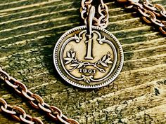 "Are you looking for a unique and personal gift? Look no further than our Austria coin pendant!  Whether it's your friend, family member, or loved one, this necklace is sure to please. Give the gift of collectable coin jewelry today!   Choose Your Year  ** Any of my Necklace Pendants can be made in a Keychain. Message me to request this necklace to be a Keychain for the same price. A small piece of a place you visited, or your home country. Looking for that special piece of jewelry that connects you to the past, look no further.  A small piece of history filled with memories from its travels around the world. Nice gift for a friend. And a great conversation starter.  Each coin has been cleaned, polished to a high shine. Comes with a 24\" chain. Two coats of protective sealer have been appl Coin Necklace With Charms Pendant As A Gift, Coin Shaped Charm Necklace Gift, Coin Shaped Charm Necklace For Gift, Gift Coin Necklace With Pendant Charms, Handmade Gold Jewelry For Father's Day, Stamped Pendant Jewelry For Anniversary Gift, Antique Coin Necklace As A Gift, Engraved Coin Necklaces For Anniversary, Antique Coin Necklace Gift