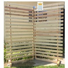 a wooden privacy screen in the grass