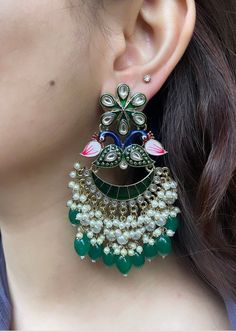 These beautiful Kundan earrings are the perfect accessory to brighten up your outfit. They are lightweight and high quality, and sure to become a staple in your jewellery collection.  Available in 3 beautiful colours: lilac purple, dark green and hot pink.  In case of any queries, please feel free to contact us. Happy shopping! Festive Green Pearl Earrings, Peacock Design Drop Earrings For Party, Green Fusion Style Party Earrings, Elegant Peacock Design Earrings For Party, Peacock Design Dangle Earrings For Party, Elegant Multicolor Peacock Design Jhumkas, Party Jhumkas With Peacock Design, Multicolor Peacock Design Earrings For Party, Party Peacock Design Dangle Earrings