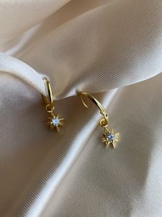 14K Gold plated 925 Sterling Silver Star hoop earrings. Minimalist style. Everyday jewelry made with love. DETAILS * 14K Gold Plated * 925 Sterling Silver * AAA Cubic Zirconia Stone * Lead Free and Nickel Free MEASURES Hoop Diameter: 16mm (1.6cm) Charm Size:10mm (1cm) PACKAGE: All jewelry comes in beautiful packaging, gift ready. ABOUT FALA All our work is made with love in Santa Monica, California. We love our customers and will make sure you're well taken care of. ENTER OUR SHOP HERE for more Elegant Dangle Hoop Earrings With Star Charm, Celestial Star Huggie Earrings, Everyday Star Shaped Pierced Earrings, Everyday Celestial Star Earrings, Celestial Star Charm Earrings For Everyday, Gold Plated Star Hoop Earrings Tarnish Resistant, Everyday Celestial Earrings With Star Charm, Gold Plated Star Hoop Earrings, Gold Plated Star-shaped Pierced Earrings