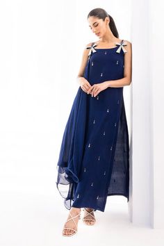 Exude charm in this midnight blue colored georgette draped shirt with minimalistic kamadani work. The sleeves have a bejewelled silver bow detailing that add to the charm. The look is paired with matching raw silk trousers Elegant Evening Palazzo Set With Mirror Work, Elegant Blue Palazzo Set For Party, Blue Raw Silk Dress With Mirror Work, Blue Silk Dress With Cutdana Details, Elegant Blue Floor-length Palazzo Set, Elegant Floor-length Blue Palazzo Set, Blue Silk Kurta With Cutdana, Blue Semi-stitched Silk Dupatta, Semi-stitched Indigo Dupatta