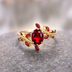 Introducing our Natural Red Garnet Leaf Ring, a luxurious and nature-inspired symbol of love and commitment. Crafted with precision and passion, this exquisite engagement ring is bathed in the warm glow of 14K yellow gold vermeil, creating a timeless piece that radiates elegance. ►At the heart of this stunning ring is a rich, natural red garnet gemstone, chosen for its deep and captivating hue. As the birthstone for January, garnet is believed to symbolize love, passion, and commitment, making it an ideal choice for expressing the depth of your emotions. ►The design of this engagement ring is nothing short of enchanting, featuring a meticulously detailed leaf motif that delicately wraps around the band. The intertwining leaves not only add a touch of organic beauty but also evoke the symbo Couples Ring Set, Leaf Motif, Ring Ideas, Leaf Ring, Creating Jewelry, Tony Awards, Garnet Gemstone, Couple Rings, Red Fire